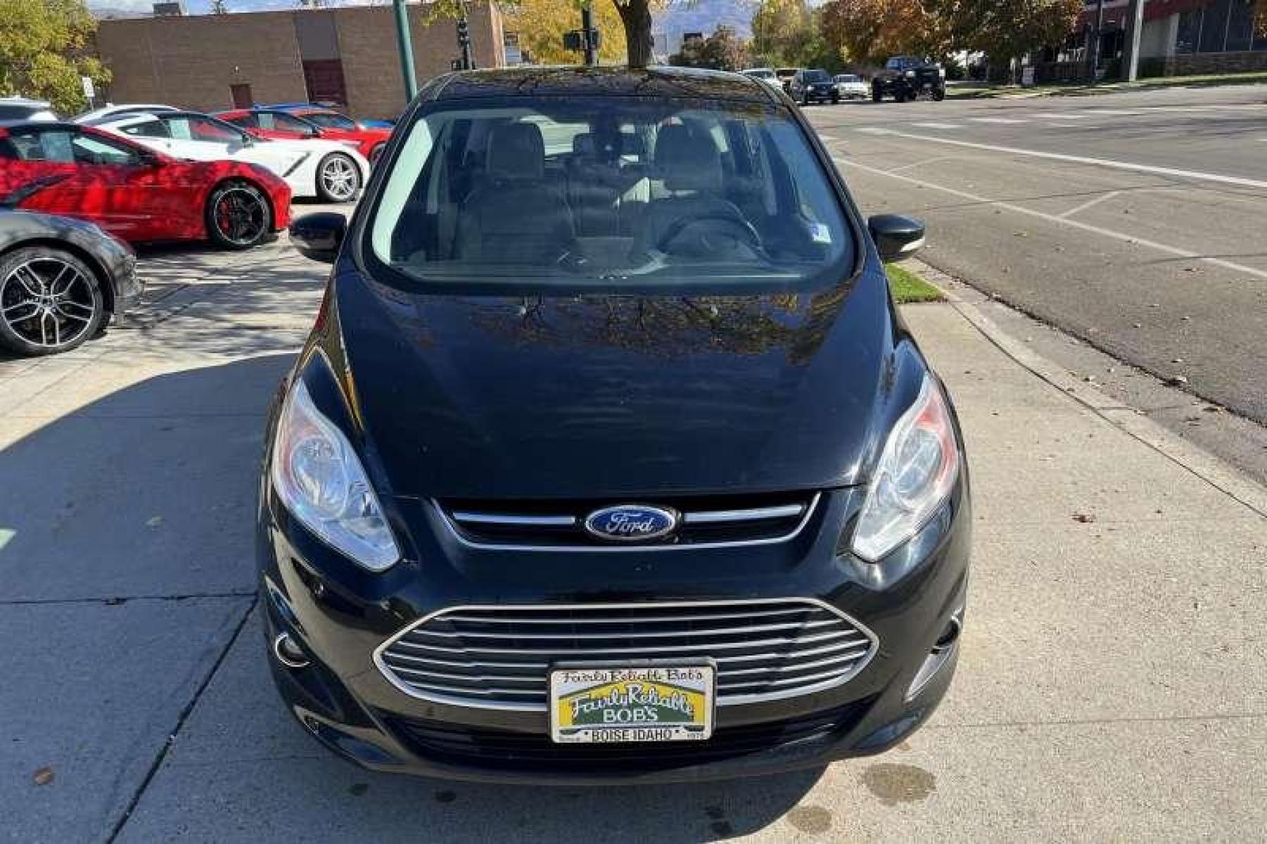 2016 Black /Tan Ford C-Max Energi Hatchback SEL (1FADP5CU9GL) with an 4 Cyl 2.0 Liter Hybrid engine, Automatic transmission, located at 2304 W. Main St., Boise, ID, 83702, (208) 342-7777, 43.622105, -116.218658 - Recharging on the run lets the C-Max Energi's power management system regularly deliver short bursts of all-electric travel, which can stretch overall fuel economy to nearly 90 MPGe. Operating only in standard hybrid mode when the initial battery charge is depleted, the C-Max Energi delivers up to 3 - Photo #1