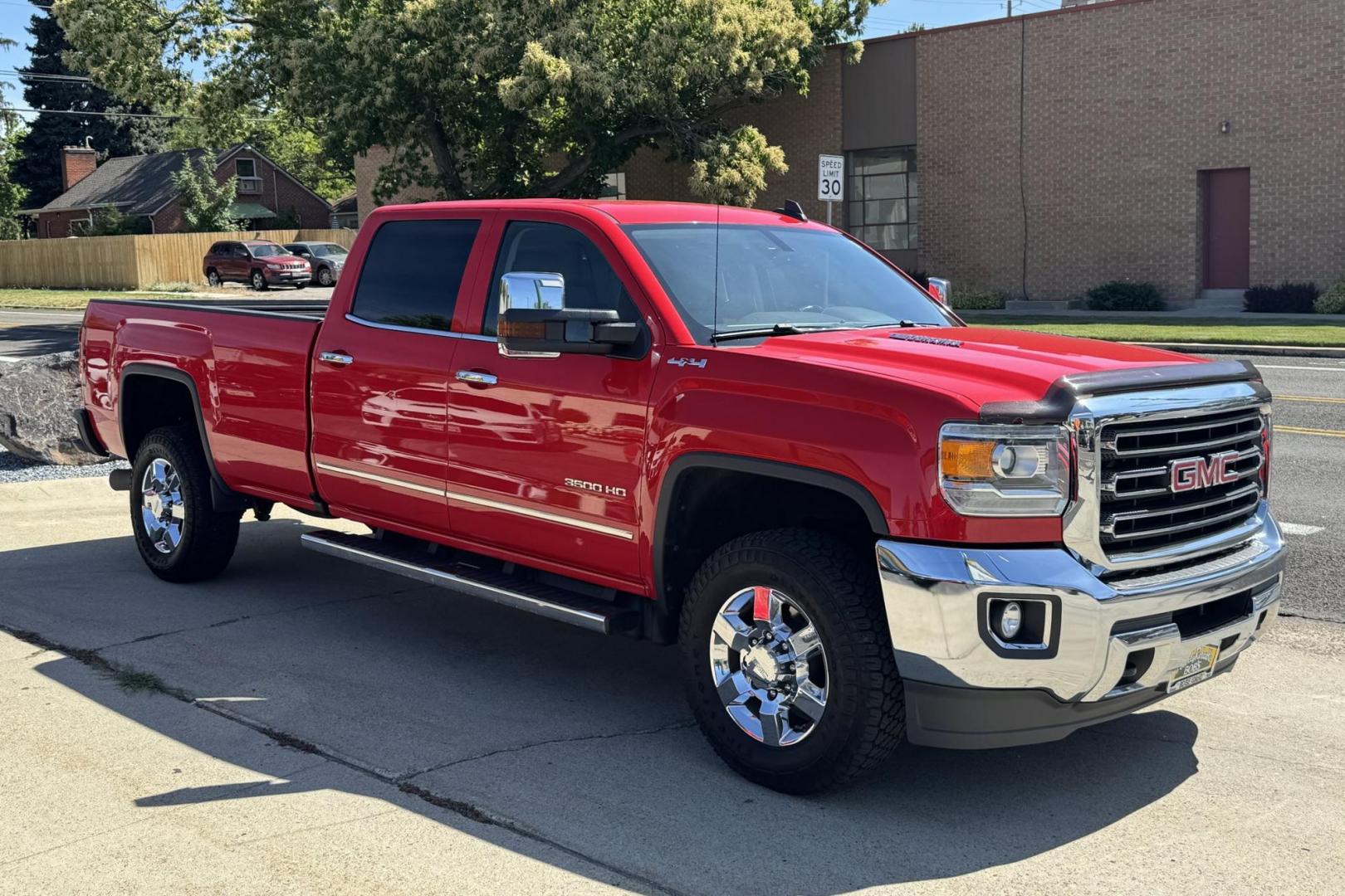 2016 Victory Red /Tan GMC Sierra 3500HD SLT (1GT42XC89GF) with an V8 6.6 Liter Turbo Duramax Diesel engine, Automatic 6 Speed With Overdrive Allison transmission, located at 2304 W. Main St., Boise, ID, 83702, (208) 342-7777, 43.622105, -116.218658 - Long Bed! Capable Hauler! - Photo#2