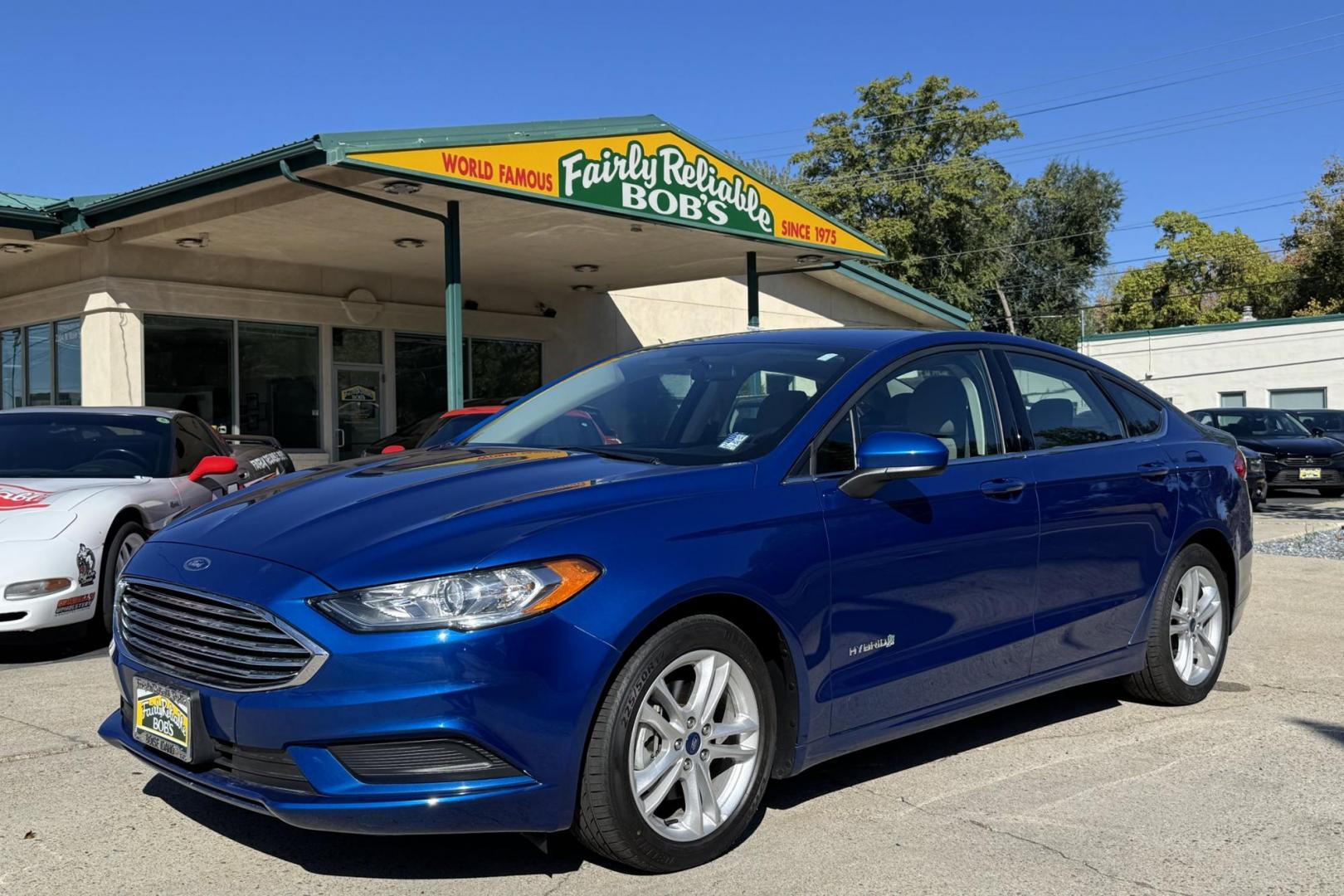 2018 Blue Lightning Metallic /Gray Ford Fusion (3FA6P0UU3JR) with an 4 Cyl 2.0 Liter Hybrid engine, Automatic transmission, located at 2304 W. Main St., Boise, ID, 83702, (208) 342-7777, 43.622105, -116.218658 - Great Fuel Economy! Smooth Ride Too! - Photo#0