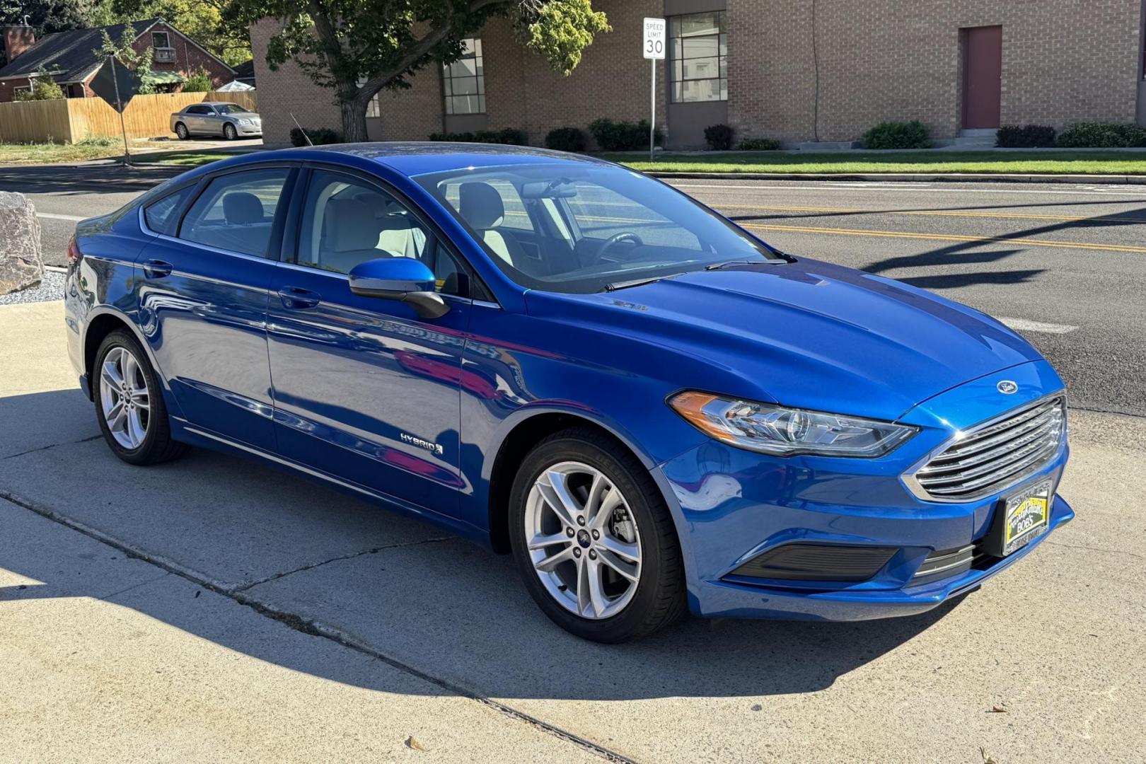 2018 Blue Lightning Metallic /Gray Ford Fusion (3FA6P0UU3JR) with an 4 Cyl 2.0 Liter Hybrid engine, Automatic transmission, located at 2304 W. Main St., Boise, ID, 83702, (208) 342-7777, 43.622105, -116.218658 - Great Fuel Economy! Smooth Ride Too! - Photo#2