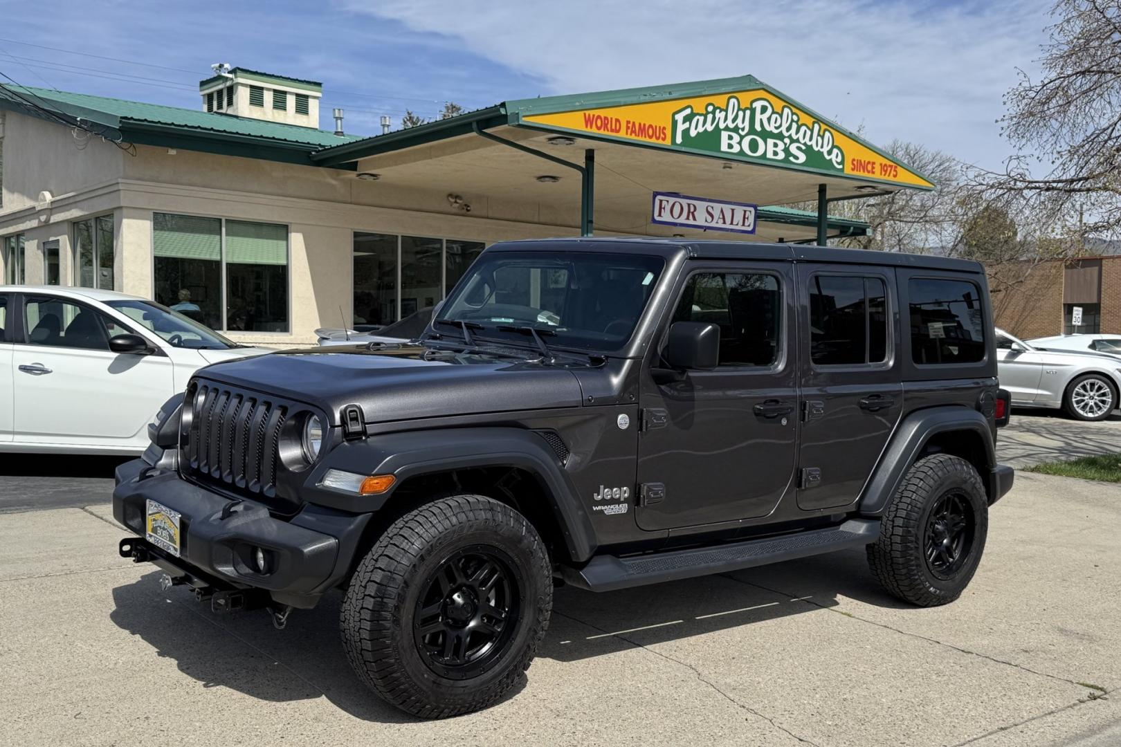 2018 Gray /Black Jeep Wrangler Unlimited Sport (1C4HJXDG1JW) with an V6 3.6 Liter engine, Automatic 8 Speed transmission, located at 2304 W. Main St., Boise, ID, 83702, (208) 342-7777, 43.622105, -116.218658 - Dinghy Tow Ready! - Photo#0